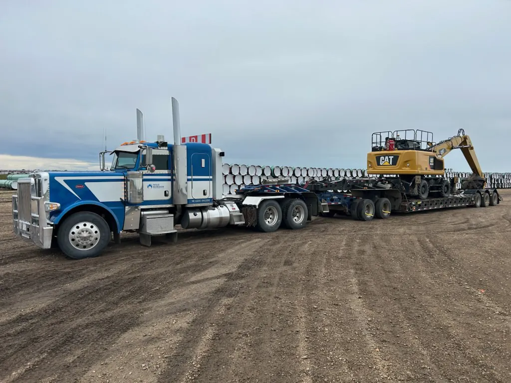 Wild Horizon Ventures peterbilt hauling cat excavator lowbed