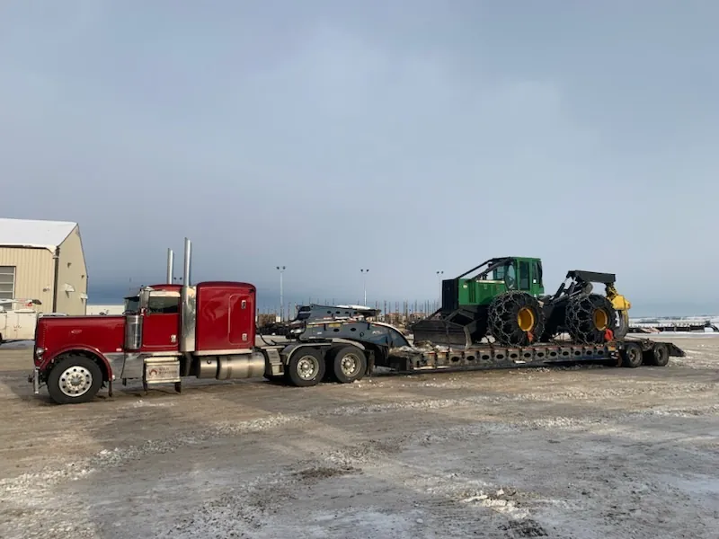 Wild Horizon Ventures peterbilt lowbed hauling john deere skidder